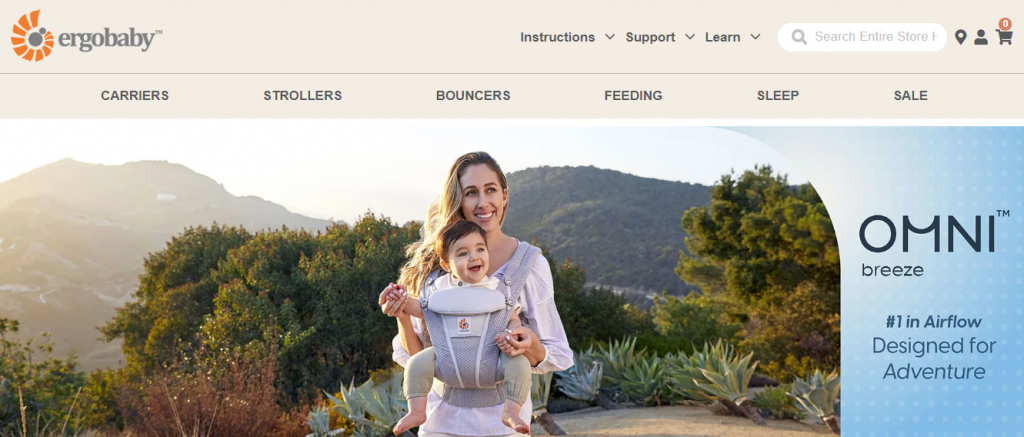 A page on the Ergobaby website showcasing their baby carrier Omni Breeze with a photo of a woman holding a baby using the product.