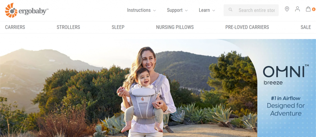 A page on the Ergobaby website showcasing their baby carrier Omni breeze with a photo of a woman holding a baby using the product